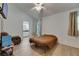 Bedroom featuring hardwood floor, ceiling fan, and view into the bathroom at 9041 58Th N St, Pinellas Park, FL 33782