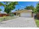 Charming single-story home with a brick driveway, white picket fence, and well-maintained landscaping at 9041 58Th N St, Pinellas Park, FL 33782