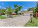 Charming single-story home with a brick driveway, white picket fence, and well-maintained landscaping at 9041 58Th N St, Pinellas Park, FL 33782