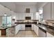 Modern kitchen featuring white cabinetry, granite countertops, stainless steel appliances, and stylish pendant lighting at 9041 58Th N St, Pinellas Park, FL 33782