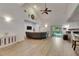 Bright and open living room featuring vaulted ceilings, wood floors, and a sliding door to the backyard at 9041 58Th N St, Pinellas Park, FL 33782