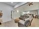 Comfortable living room featuring vaulted ceilings, wood floors, and an open layout connected to the kitchen at 9041 58Th N St, Pinellas Park, FL 33782