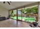 View of the artificial turf backyard from the screened patio at 9041 58Th N St, Pinellas Park, FL 33782