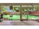 View of the fenced-in artificial turf backyard from screened patio at 9041 58Th N St, Pinellas Park, FL 33782