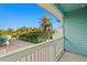 Balcony view showing the exterior streetscape and lush tropical landscaping at 20060 Gulf Blvd, Indian Shores, FL 33785