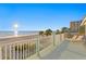 Balcony with lounge chairs and views of the beach and a brilliant sun at 20060 Gulf Blvd, Indian Shores, FL 33785