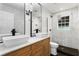 Modern bathroom with dual vessel sinks, black hardware and large glass enclosed shower at 20060 Gulf Blvd, Indian Shores, FL 33785