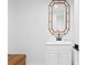 Simple bathroom with a white vanity and bamboo-framed mirror at 20060 Gulf Blvd, Indian Shores, FL 33785