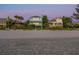 Charming beachfront homes with balconies and tropical landscaping offer stunning ocean views and direct beach access at 20060 Gulf Blvd, Indian Shores, FL 33785
