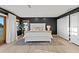 Well-lit bedroom features a large bed, a dark accent wall, and two closets at 20060 Gulf Blvd, Indian Shores, FL 33785