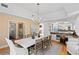 Modern dining room with coastal decor, wood floors, and an open floor plan to the kitchen at 20060 Gulf Blvd, Indian Shores, FL 33785