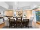 A formal dining area featuring a modern chandelier, wood flooring and paneled ceiling detail at 20060 Gulf Blvd, Indian Shores, FL 33785