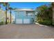 Lovely two-story beach house with a spacious garage and charming curb appeal at 20060 Gulf Blvd, Indian Shores, FL 33785