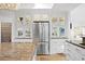 This sleek kitchen features granite countertops, glass cabinetry, and stainless steel appliances for a modern aesthetic at 20060 Gulf Blvd, Indian Shores, FL 33785