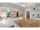 Gourmet kitchen with granite counters and adjacent dining area provides a seamless flow for modern living at 20060 Gulf Blvd, Indian Shores, FL 33785