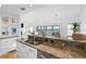 Kitchen with granite countertops, breakfast bar and stainless appliances overlooking an outdoor living space at 20060 Gulf Blvd, Indian Shores, FL 33785