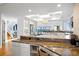 Open kitchen with granite countertops, modern appliances, and views of the water at 20060 Gulf Blvd, Indian Shores, FL 33785