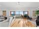 Bright living room with hardwood floors, sliding glass doors with beach and ocean views, and comfortable seating at 20060 Gulf Blvd, Indian Shores, FL 33785