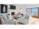 Cozy living room featuring a fireplace, comfortable seating, and stunning ocean views through sliding glass doors at 20060 Gulf Blvd, Indian Shores, FL 33785