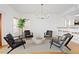 Bright living room featuring sleek, modern furniture, hardwood floors and a view of the kitchen at 20060 Gulf Blvd, Indian Shores, FL 33785