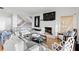 Bright living room featuring a fireplace, comfortable seating, and an adjacent staircase, creating a relaxing atmosphere at 20060 Gulf Blvd, Indian Shores, FL 33785
