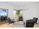 Bright living room featuring sleek, modern furniture, hardwood floors and beautiful water views at 20060 Gulf Blvd, Indian Shores, FL 33785