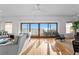 Living room with hardwood floors, sliding glass doors with beach and ocean views, and comfortable seating at 20060 Gulf Blvd, Indian Shores, FL 33785