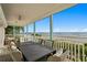 Charming covered patio area with comfortable seating and an ocean view at 20060 Gulf Blvd, Indian Shores, FL 33785
