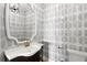 Stylish powder room featuring designer wallpaper, vessel sink, and modern fixtures offers a touch of elegance at 20060 Gulf Blvd, Indian Shores, FL 33785