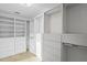 Bright walk-in closet with adjustable shelving, drawers and hanging rods to maximize storage at 20060 Gulf Blvd, Indian Shores, FL 33785