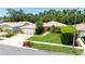 Aerial shot of a home featuring a lush front lawn, tropical landscaping, and an inviting walkway at 11116 118Th St, Seminole, FL 33778