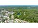 An aerial shot of houses in a neighborhood with ponds in between with lush green trees at 11116 118Th St, Seminole, FL 33778