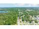 A distant view of a community surrounded by lush green trees and a lake at 11116 118Th St, Seminole, FL 33778