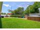 Expansive backyard featuring a hot tub, patio with seating, and lush green lawn at 11116 118Th St, Seminole, FL 33778