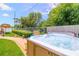 Inviting backyard featuring a bubbling hot tub surrounded by lush landscaping and a well-maintained lawn at 11116 118Th St, Seminole, FL 33778
