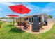 Inviting backyard with a brick patio, outdoor dining area, and a built-in grill at 11116 118Th St, Seminole, FL 33778