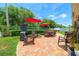 Lush backyard with a brick patio, outdoor seating, and mature landscaping at 11116 118Th St, Seminole, FL 33778