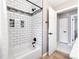 Updated bathroom with a white tub and shower combo featuring white tile, and modern hardware at 11116 118Th St, Seminole, FL 33778