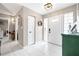 Bright foyer with white tile, glass block accents, and a view into other rooms at 11116 118Th St, Seminole, FL 33778