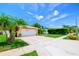 Well-maintained home with green lawn and driveway, accented by mature palm trees and manicured landscaping at 11116 118Th St, Seminole, FL 33778