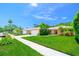 View of a well-manicured lawn and landscaping leading to a charming home with a white garage door at 11116 118Th St, Seminole, FL 33778