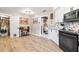 Bright kitchen features wood-look floors, white cabinetry, black appliances, and convenient access to laundry room at 11116 118Th St, Seminole, FL 33778