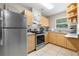 Kitchen featuring wood cabinetry, granite countertops, stainless steel appliances, and tile flooring at 11116 118Th St, Seminole, FL 33778