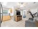 Living room featuring a ceiling fan, TV, tile flooring, and doorway to bedroom at 11116 118Th St, Seminole, FL 33778