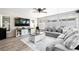 Bright sunroom featuring a large sectional sofa, mounted TV, and sliding glass doors at 11116 118Th St, Seminole, FL 33778