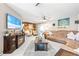 Inviting living room featuring a wood accent wall, comfortable seating, and ample natural light at 11116 118Th St, Seminole, FL 33778