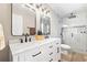 Beautifully renovated main bathroom featuring dual sinks, marble counters, and a tiled walk-in shower at 11116 118Th St, Seminole, FL 33778