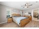 Inviting main bedroom features wood-look floors, ceiling fan, natural light and ensuite bathroom access at 11116 118Th St, Seminole, FL 33778