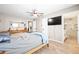 Spacious main bedroom boasts wood-look floors, a ceiling fan, and ensuite bathroom access at 11116 118Th St, Seminole, FL 33778