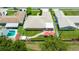 An aerial view of a private fenced yard with a spa, patio, landscaping, and red umbrellas at 11116 118Th St, Seminole, FL 33778